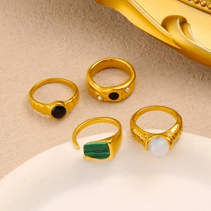 Macro shot of 18K gold plated stainless steel rings with pearl and gemstone details