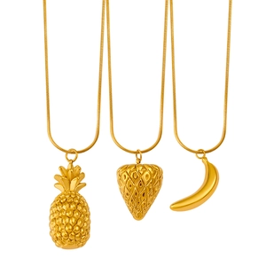 Golden stainless steel pineapple, strawberry and banana fruit pendant necklaces on white