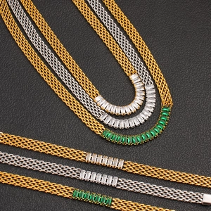 Detail of multi-layer mesh chain with baguette-cut emerald and white stones on leather base