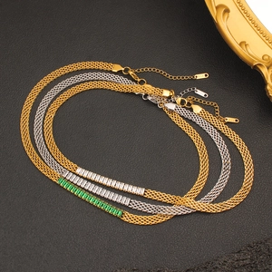 Detail of 18k gold mesh chains with emerald and white zircon rectangular stones