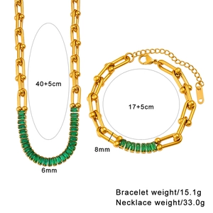 Detail view of gold horseshoe link necklace and bracelet set with green zircon stones
