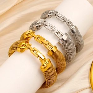 Detail of 18K gold and silver mesh bracelets on white pedestals with satin background