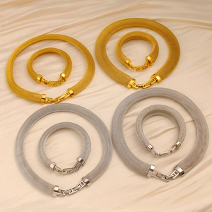 Mesh chain jewelry set with 18K gold plated necklace and bracelet on silk background