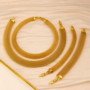 Detail of the high-quality 18K gold stainless steel mesh jewelry set on silk background