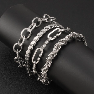 Detailed view of four assorted silver stainless steel geometric link chains on display
