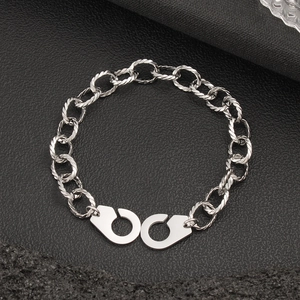 Detailed view of silver stainless steel twisted link bracelet with handcuff clasp design