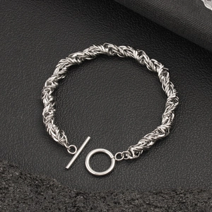 Detail of vintage silver stainless steel woven chain bracelet with classic OT toggle clasp