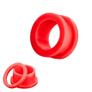 Macro detail of red acrylic ear gauge plug with screw-in design and matte finish