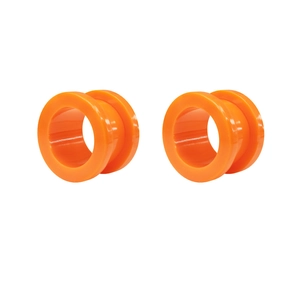 Macro shot of bright orange acrylic ear tunnels with a polished finish for ear piercings