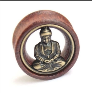 Ethnic wood ear plug tunnels featuring a bronze Buddha inlay for lobe piercing