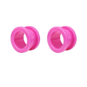 Macro view of vibrant pink acrylic ear plugs with double flare design and high gloss finish