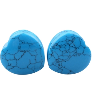 Detail of blue turquoise heart ear plugs with black marble texture for ear piercing