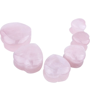 Detailed arrangement of heart-shaped natural pink stone ear gauges in various sizes