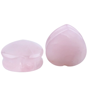 Pink quartz heart shaped ear gauge with smooth polished surface and saddle plug design