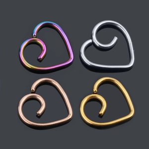 Detail of heart-shaped ear studs in iridescent, silver, rose gold, and gold finishes