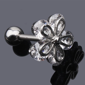 Macro shot of silver flower piercing earring with clear cubic zirconia stones and ball back