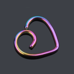 Macro shot of iridescent heart-shaped daith piercing ring with smooth rainbow finish