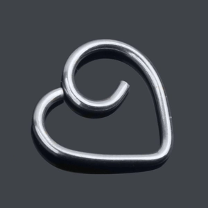 Macro view of a silver heart-shaped spiral ear cuff with a polished stainless steel finish