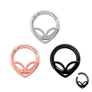 Detailed macro view of alien-shaped hinged segment nose rings in silver, gold, and black colors