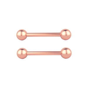 Detail view of rose gold stainless steel barbell body jewelry with polished spheres
