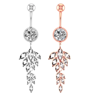 Macro detail of belly rings with leaf-shaped marquise zircon tassels in silver and rose gold