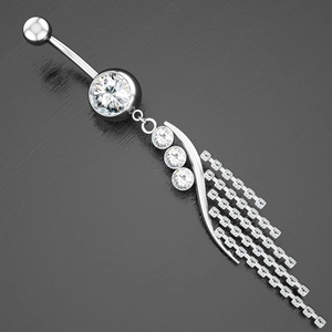 Detailed close-up of a silver belly ring with zircon inlays and long cascading tassels