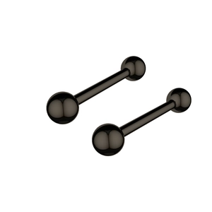 Detailed view of matte black surgical steel barbell piercings with smooth round spheres