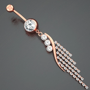 Detailed macro of rose gold belly button ring with sparkling zircon tassel design