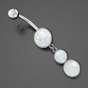 Detailed view of silver belly ring with three dangling white opal stones on grey surface