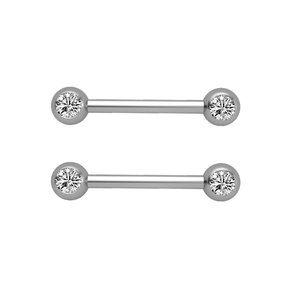 Detailed close-up of two polished stainless steel piercing studs with clear cubic zirconia