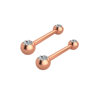 Detailed macro view of two rose gold barbell piercings with sparkling zircon stones