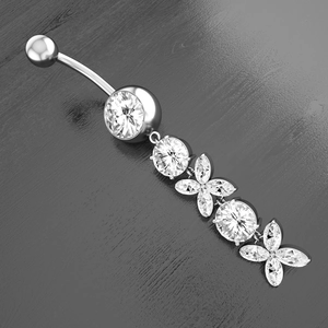 Macro detail of silver navel ring with marquise zircon butterfly pendant on dark wood