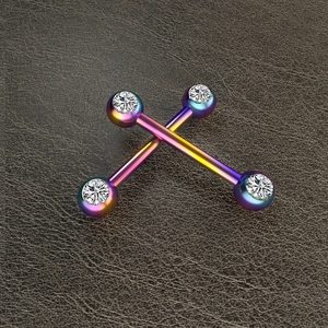 Macro view of oil slick finish barbell piercings with sparkling cubic zirconia crystals