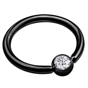 Detail of a black surgical steel hinged nose ring set with a clear sparkling zircon