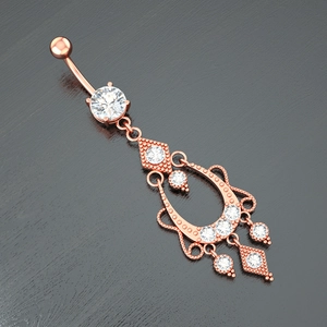 Macro shot of rose gold navel ring with vintage chandelier pendant and clear cubic zirconia