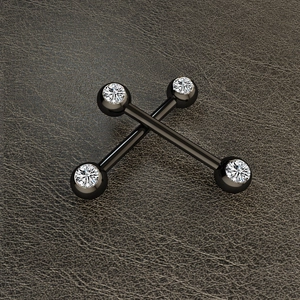 Macro view of two black stainless steel barbells with clear crystal stones on leather