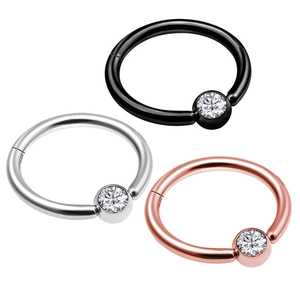 Three nose ring clickers in black, silver, and rose gold finishes with clear zircons