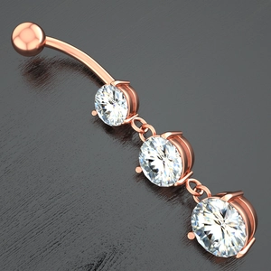 Macro shot of rose gold belly button ring with three graduated round cubic zirconia stones