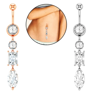 Macro detail of rose gold and silver belly rings with tiered marquise cut cubic zirconia