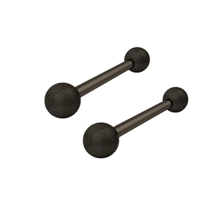 Macro view of matte black stainless steel barbell piercings with textured frosted ends