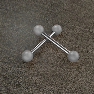Detailed macro view of barbell piercings with matte grey balls on leather background