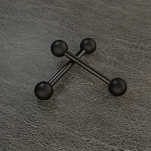 Macro view of black stainless steel tongue rings in an X-shape on grey leather surface