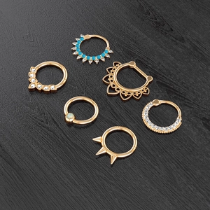 Detailed set of golden nose rings with zircon, turquoise beads, and punk spike designs