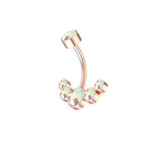 Macro detail of rose gold navel ring with rainbow AB cubic zirconia stones and curved bar