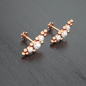 Macro detail of rose gold labret studs with cubic zirconia and star shaped flat backs