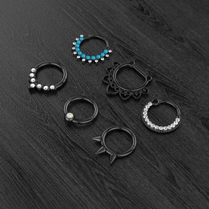Set of six black stainless steel piercing rings with zircon, opal, and spike details