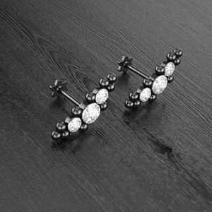 Macro view of black steel labret stud with three sparkling white cubic zirconia stones