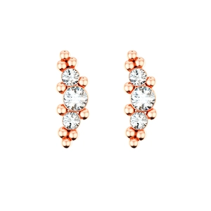 Close-up of rose gold stud earrings with three graduated clear crystals and tiny metal beads