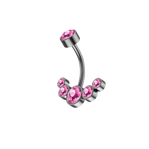 Macro detail of stainless steel belly ring with pink cubic zirconia fan shaped cluster