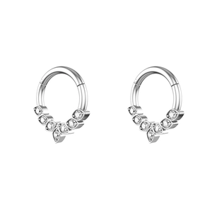 Polished stainless steel nose ring clicker with seven sparkling zircons on white background